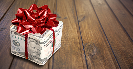Money wrapped as a gift with a large bow