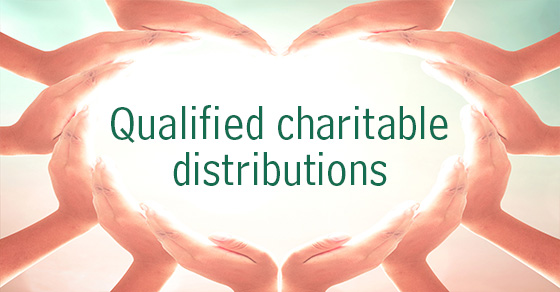 Hands in the shape of a heart around the words qualified charitable distributions