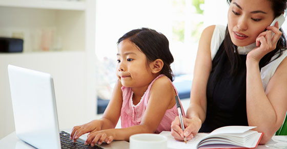 A women working at home with her child.