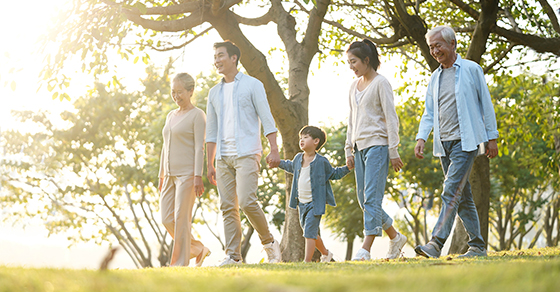 Multi-generational family take a walk in the park