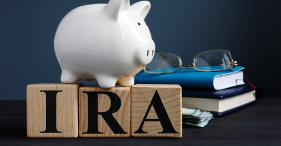Piggy bank sitting on block spelling IRA