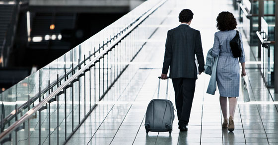 Two people walking through an airport