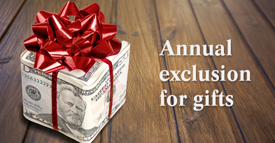 gift wrapped in $50 & $100 bills with a red ribbon on top