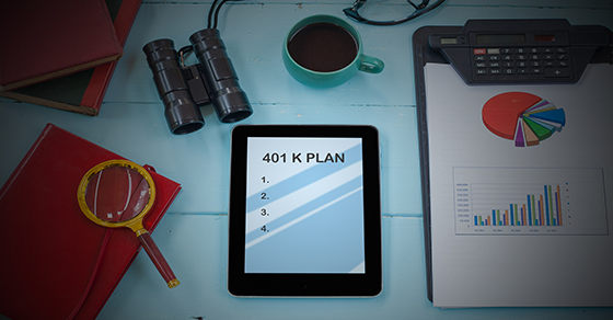 Desk covered with tablet, books, charts and a magnifying glass