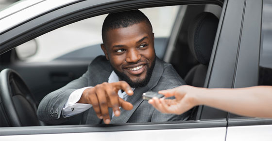 Someone handing a man car keys
