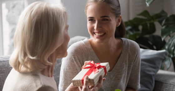 Mom giving daughter a wrapped gift