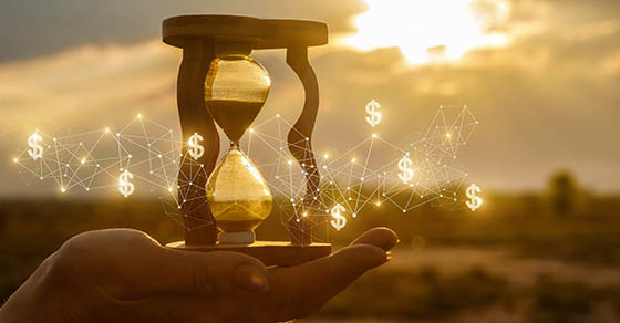 Hand holding an hourglass
