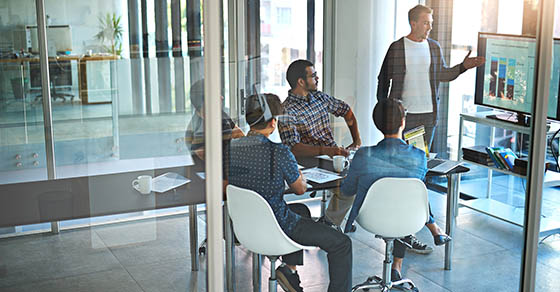 group of people meeting to go over numbers